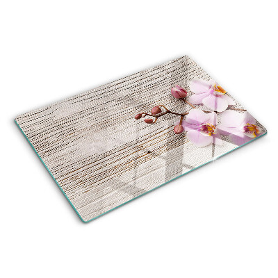 Szklana deska kuchenna z motywem orchidei na tle drewna