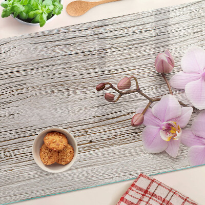 Szklana deska kuchenna z motywem orchidei na tle drewna
