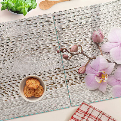 Szklana deska kuchenna z motywem orchidei na tle drewna