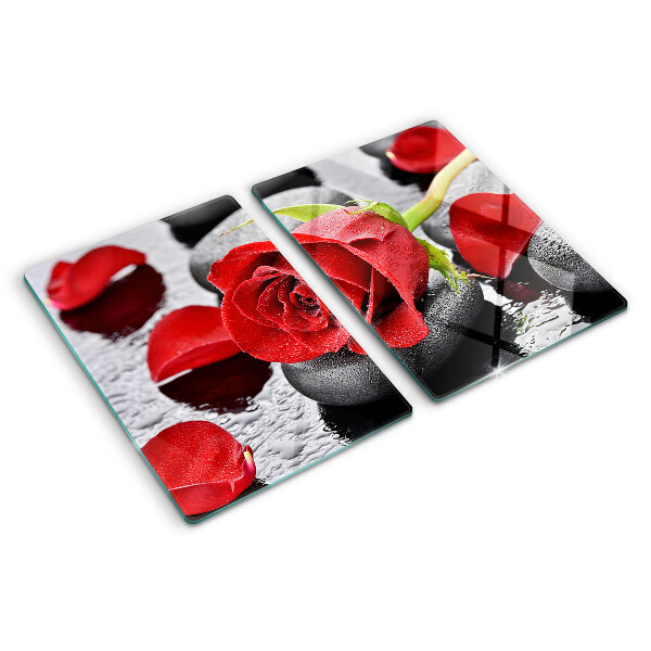 Szklana deska kuchenna z motywem róży na kamieniach z kroplami wody