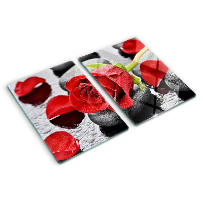 Szklana deska kuchenna z motywem róży na kamieniach z kroplami wody