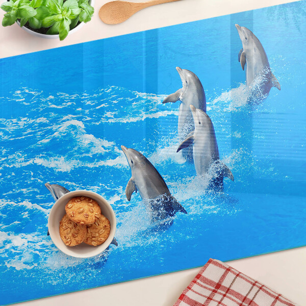 Szklana deska kuchenna z motywem delfinów skaczących przez fale