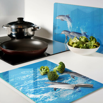 Szklana deska kuchenna z motywem delfinów skaczących przez fale