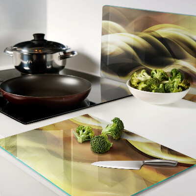 Szklana deska do krojenia z motywem abstrakcyjnych fal w odcieniach złota