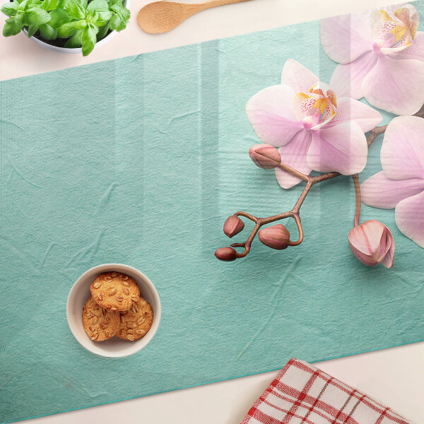 Szklana deska kuchenna z motywem orchidei na niebieskim tle