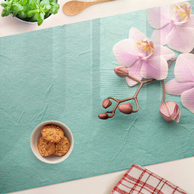 Szklana deska kuchenna z motywem orchidei na niebieskim tle