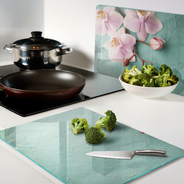 Szklana deska kuchenna z motywem orchidei na niebieskim tle