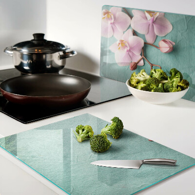 Szklana deska kuchenna z motywem orchidei na niebieskim tle