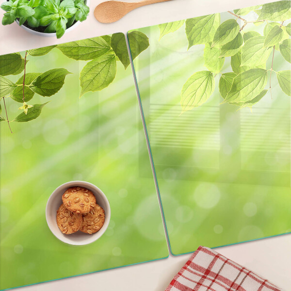 Szklana deska do krojenia z motywem zielonych liści na jasnym tle