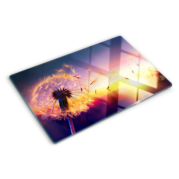 Szklana deska do krojenia z motywem dmuchawców na tle zachodu słońca