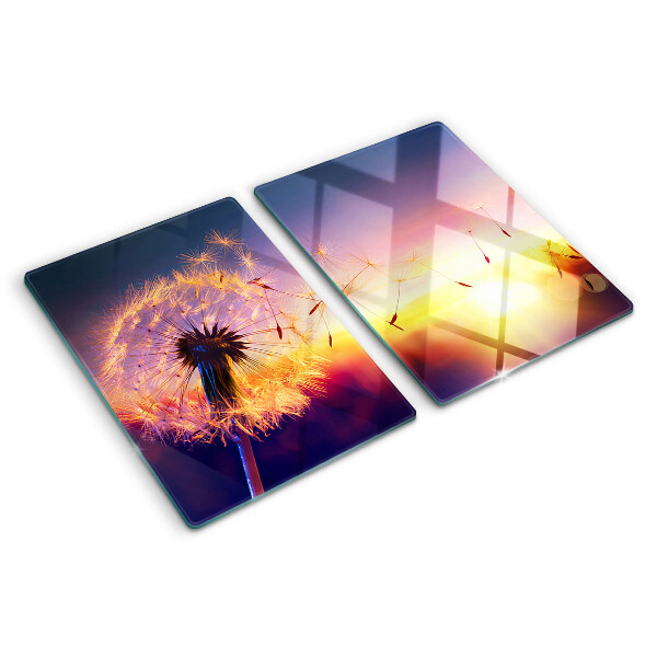 Szklana deska do krojenia z motywem dmuchawców na tle zachodu słońca