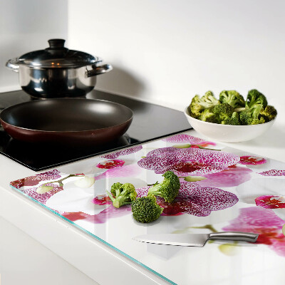 Szklana deska do krojenia z motywem orchidei na tle okna