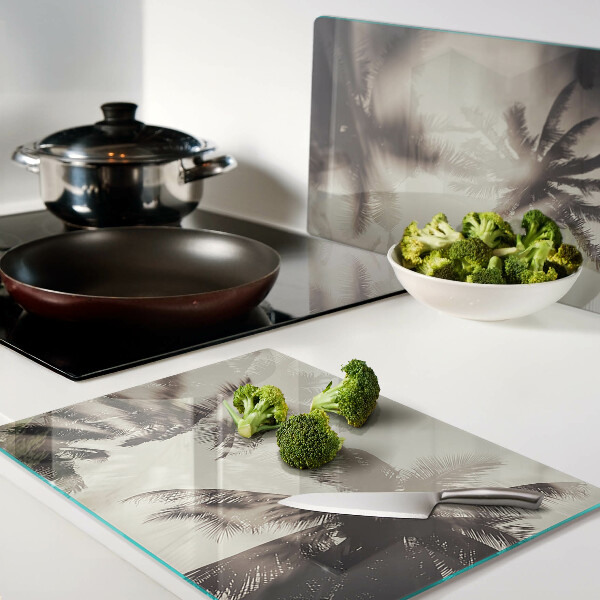 Szklana deska kuchenna z motywem palm na tle monochromatycznym