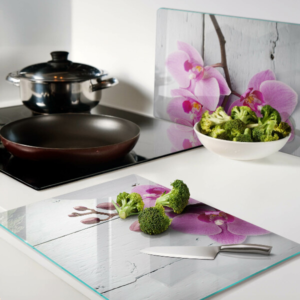 Szklana deska do krojenia z motywem orchidei na białym tle