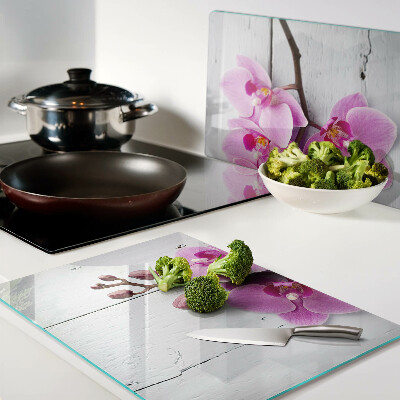 Szklana deska do krojenia z motywem orchidei na białym tle