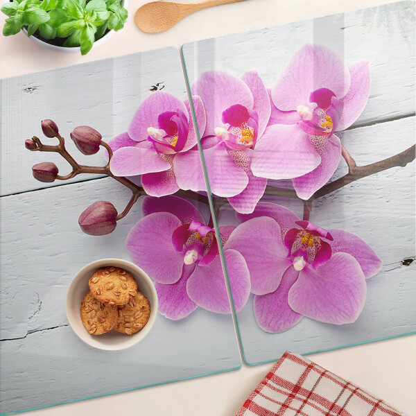 Szklana deska do krojenia z motywem orchidei na białym tle