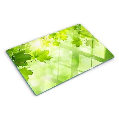 Szklana deska do krojenia z motywem liści w promieniach słońca