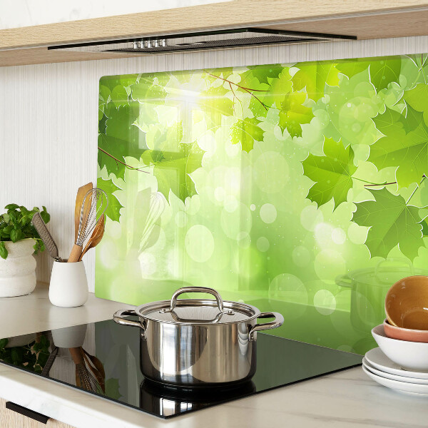 Szklana deska do krojenia z motywem liści w promieniach słońca