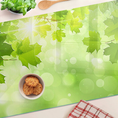 Szklana deska do krojenia z motywem liści w promieniach słońca