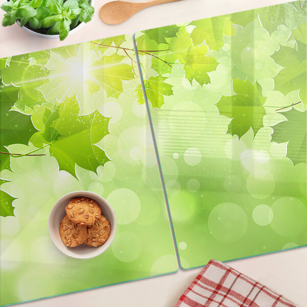 Szklana deska do krojenia z motywem liści w promieniach słońca