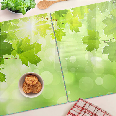 Szklana deska do krojenia z motywem liści w promieniach słońca