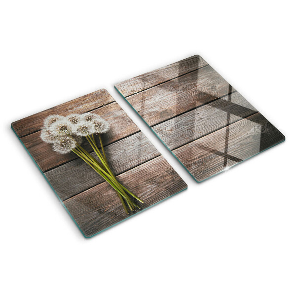 Szklana deska kuchenna z motywem dmuchawców na tle drewna