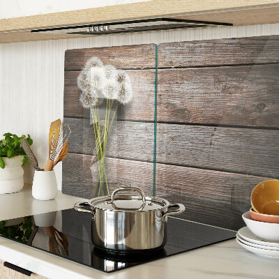 Szklana deska kuchenna z motywem dmuchawców na tle drewna