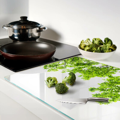 Szklana deska kuchenna z motywem zielonych liści na tle nieba