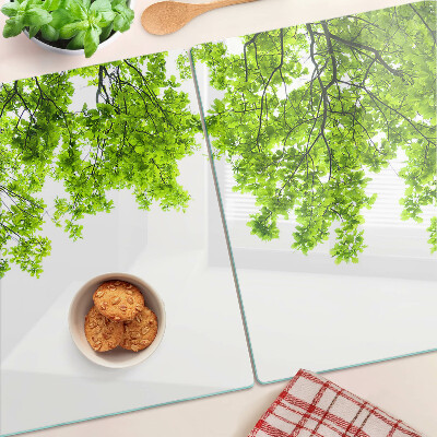 Szklana deska kuchenna z motywem zielonych liści na tle nieba