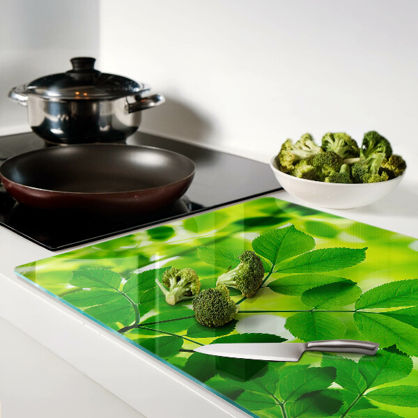 Deska kuchenna szklana z motywem liści na zielonym tle