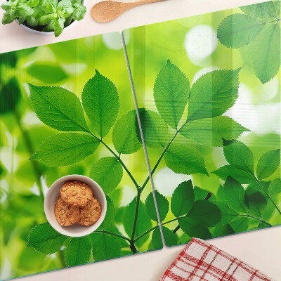 Deska kuchenna szklana z motywem liści na zielonym tle