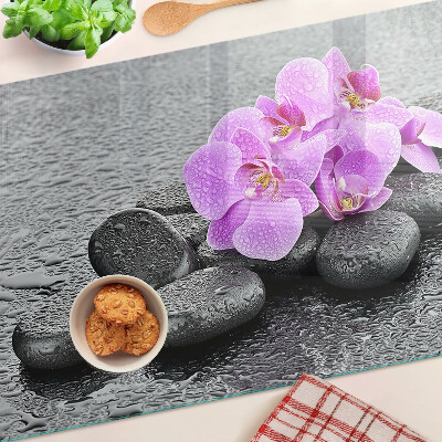 Szklana deska do krojenia z motywem kwiatów i kamieni na tle wody