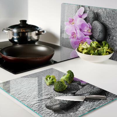 Szklana deska do krojenia z motywem kwiatów i kamieni na tle wody