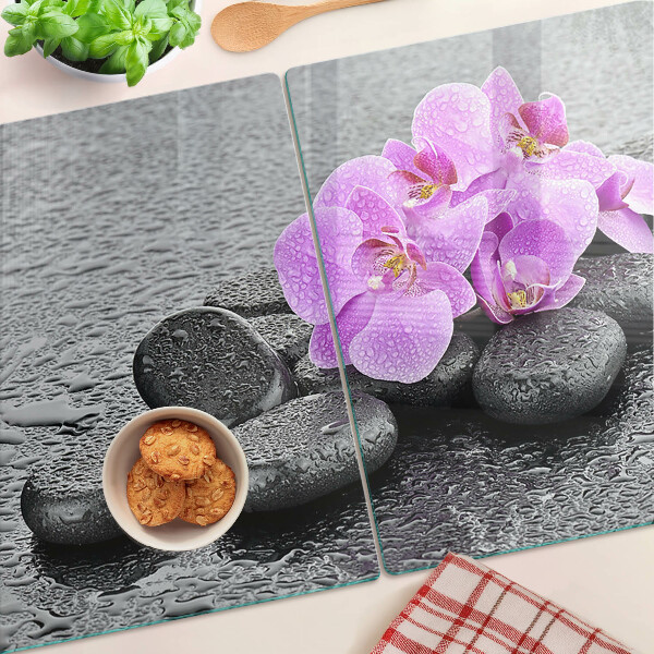 Szklana deska do krojenia z motywem kwiatów i kamieni na tle wody