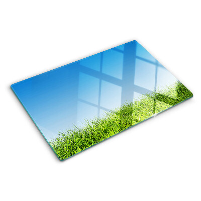 Szklana deska kuchenna z motywem zielonej łąki pod błękitnym niebem