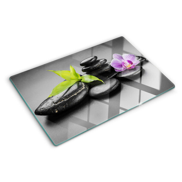Deska kuchenna szklana z motywem kamieni i orchidei na tle