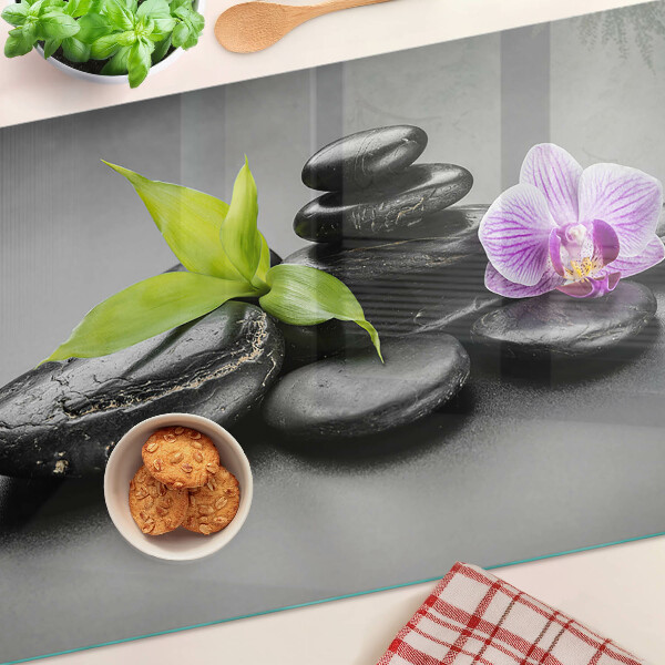 Deska kuchenna szklana z motywem kamieni i orchidei na tle