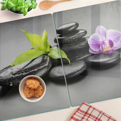 Deska kuchenna szklana z motywem kamieni i orchidei na tle
