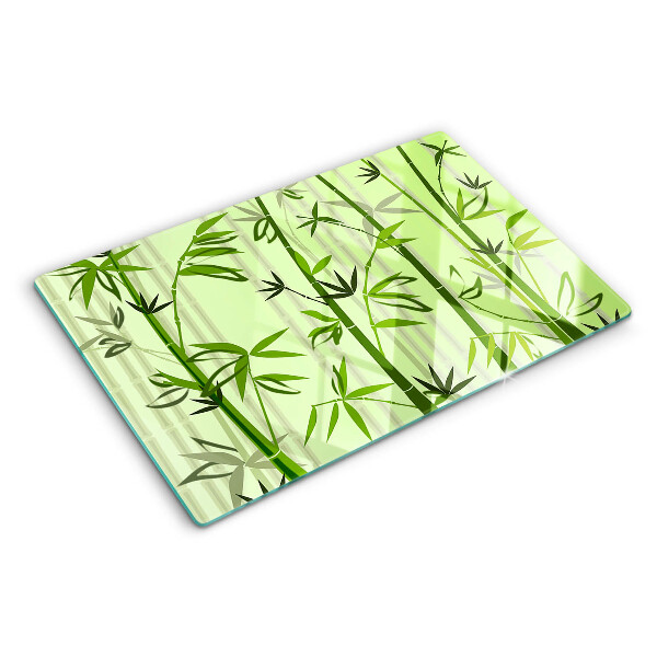 Szklana deska do krojenia z bambusowym spodem na zielonym tle