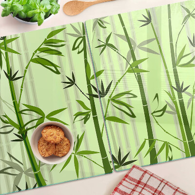 Szklana deska do krojenia z bambusowym spodem na zielonym tle