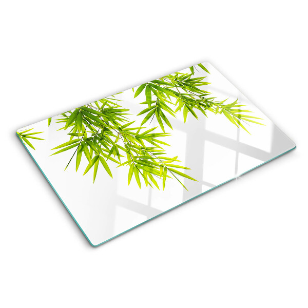 Szklana deska kuchenna z motywem liści bambusa widocznych na tle okna