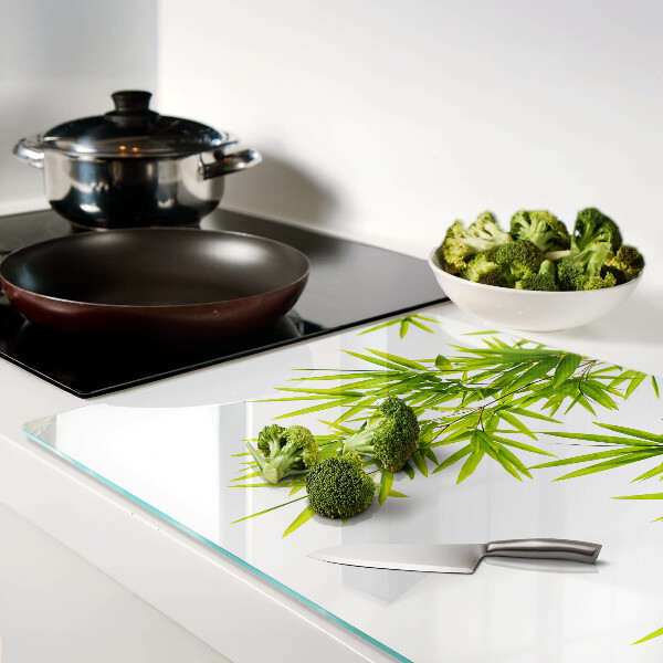 Szklana deska kuchenna z motywem liści bambusa widocznych na tle okna