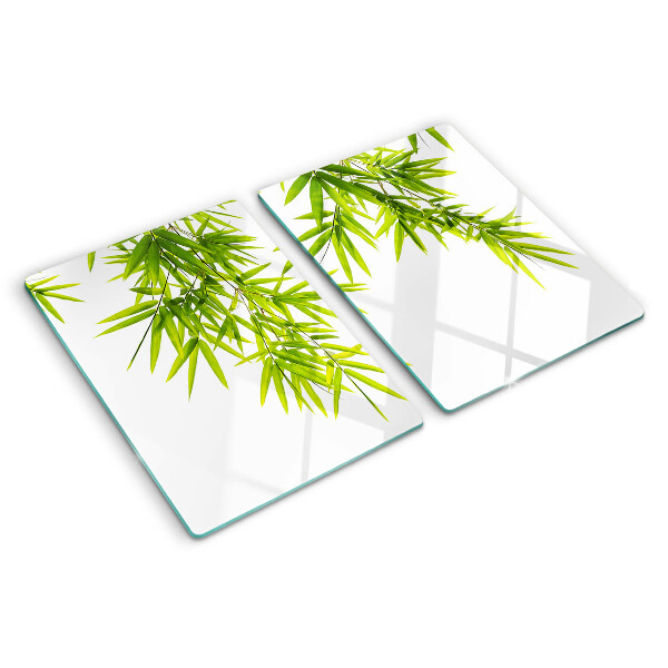 Szklana deska kuchenna z motywem liści bambusa widocznych na tle okna