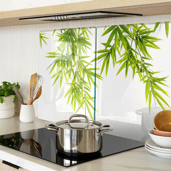 Szklana deska kuchenna z motywem liści bambusa widocznych na tle okna