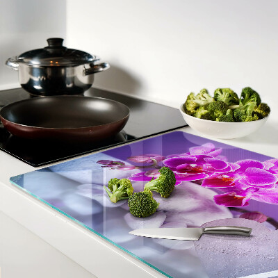 Szklana deska do krojenia z motywem orchidei na kamieniach