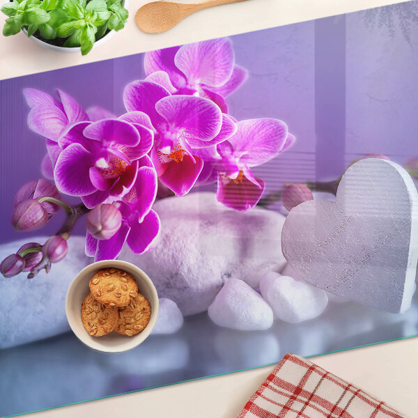 Szklana deska do krojenia z motywem orchidei na kamieniach