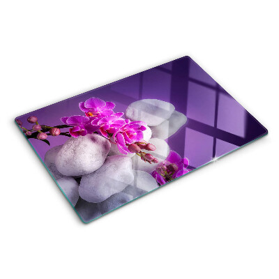 Deska kuchenna szklana z motywem kwiatów orchidei na tle kamieni