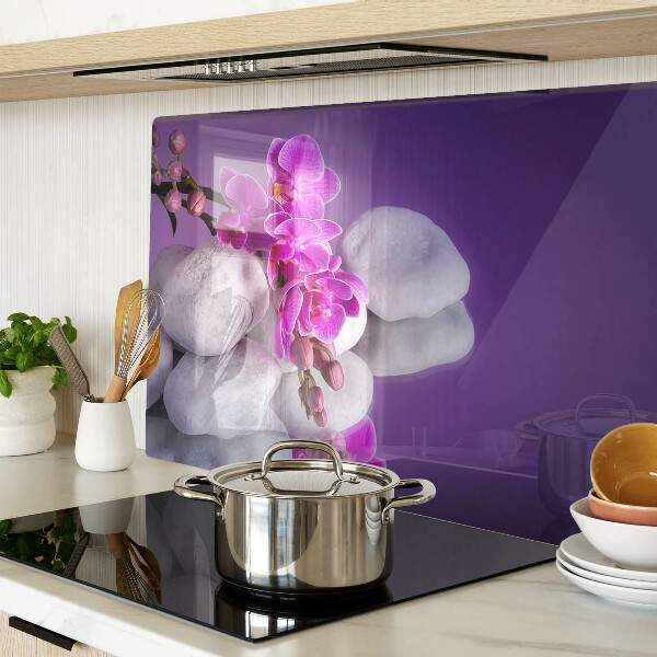 Deska kuchenna szklana z motywem kwiatów orchidei na tle kamieni