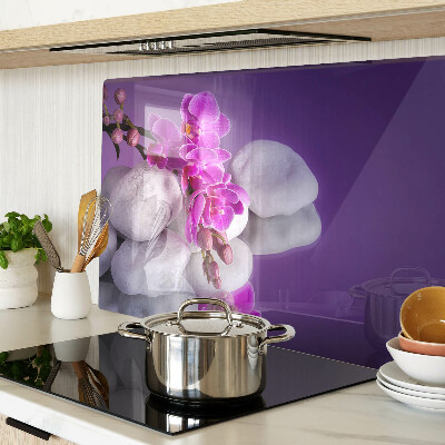 Deska kuchenna szklana z motywem kwiatów orchidei na tle kamieni