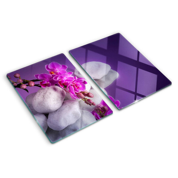 Deska kuchenna szklana z motywem kwiatów orchidei na tle kamieni